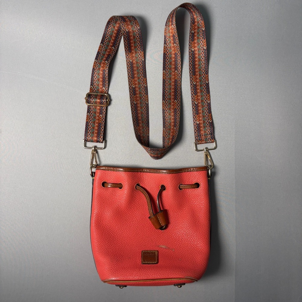 Dooney & Bourke Coral Pink Pebbled Leather Bucket Bag Geometric Guitar Strap